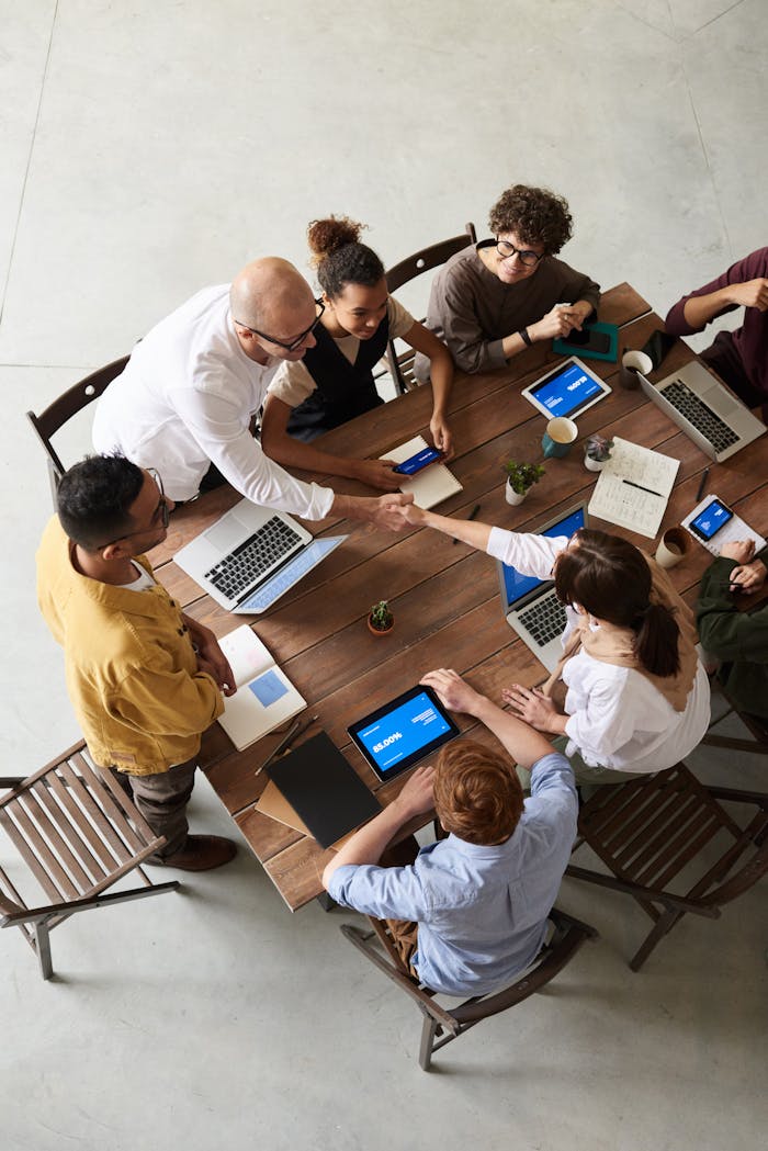 Home Overhead shot of a diverse team collaborating in a modern office meeting.